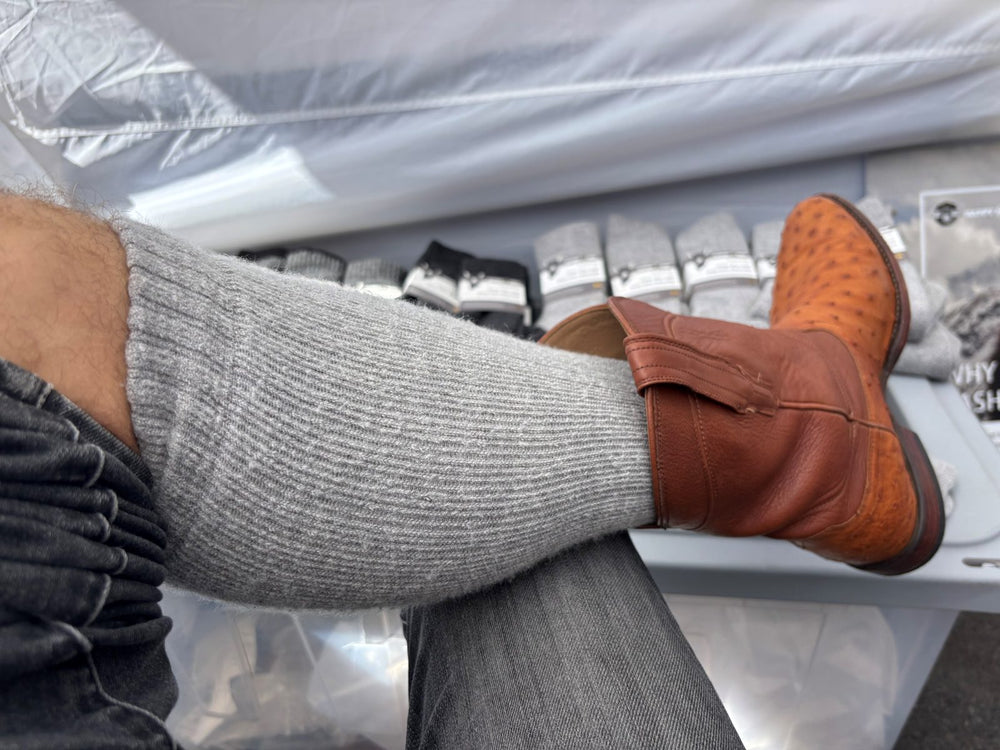Grey yak cashmere crew sock worn with a brown leather boot